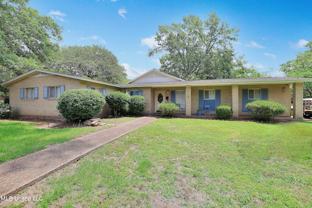 ranch-style home featuring covered porch, brick siding, and a front lawn