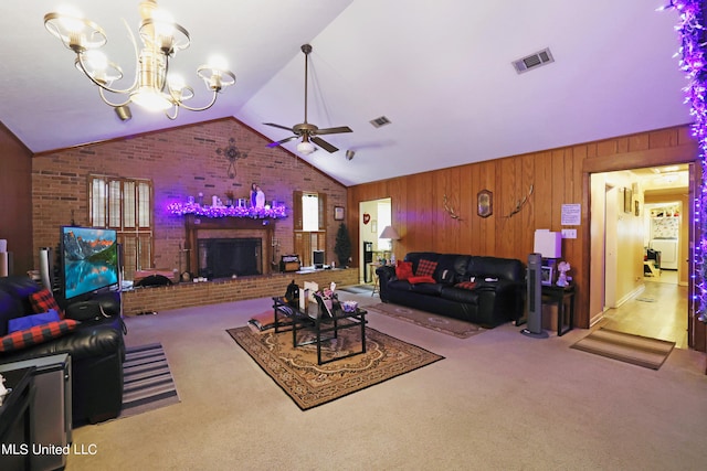 living room featuring lofted ceiling, light carpet, a fireplace, ceiling fan with notable chandelier, and wood walls