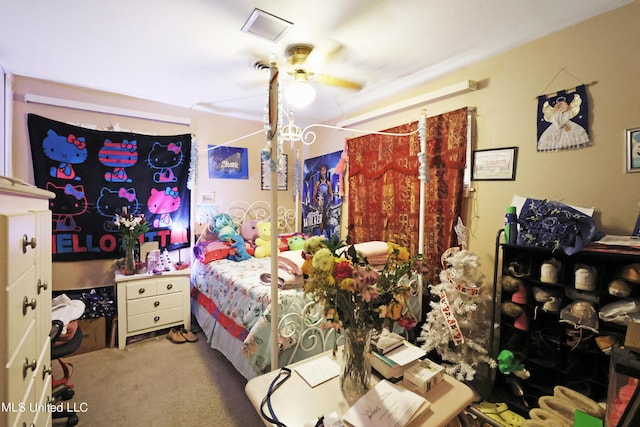 carpeted bedroom featuring visible vents and a ceiling fan