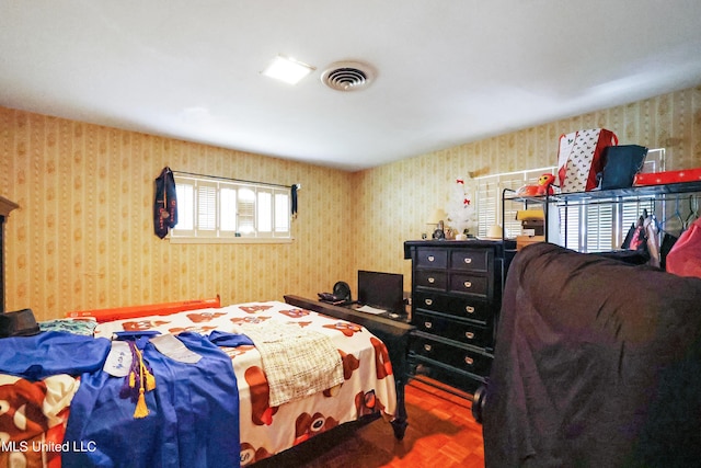 bedroom featuring visible vents and wallpapered walls