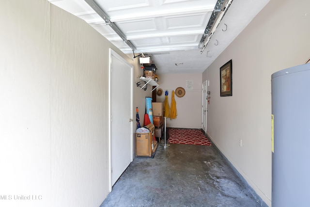 hallway featuring concrete floors and water heater
