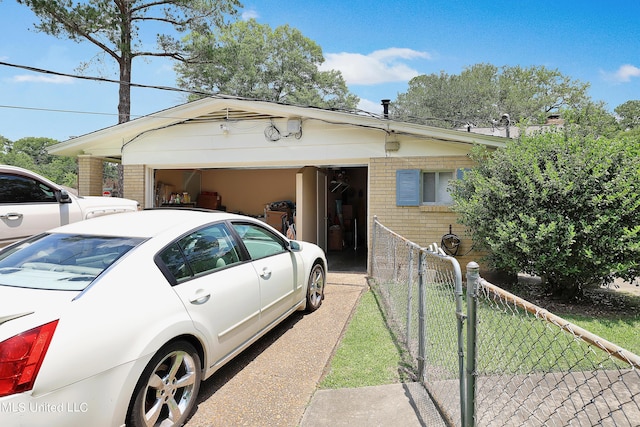 view of front of property with brick siding, an attached garage, and fence