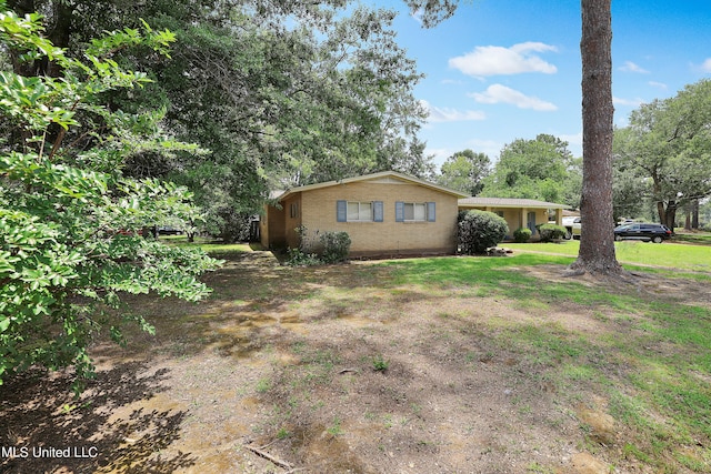 view of side of property featuring a yard