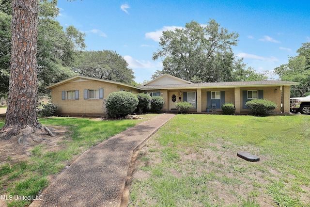 single story home with covered porch, brick siding, and a front lawn