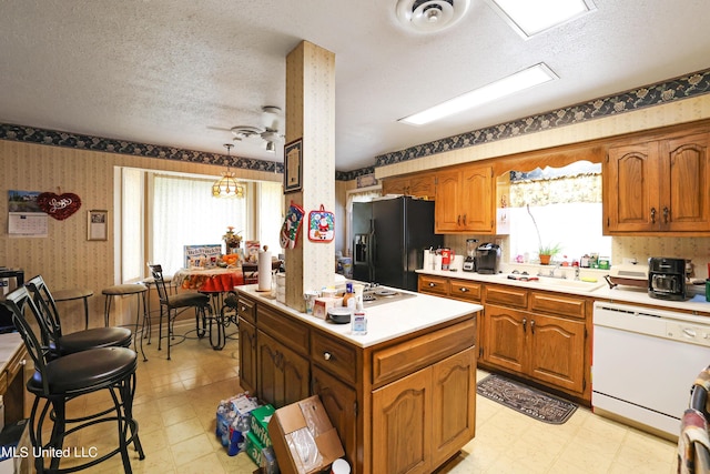kitchen with white dishwasher, light floors, black refrigerator with ice dispenser, and wallpapered walls