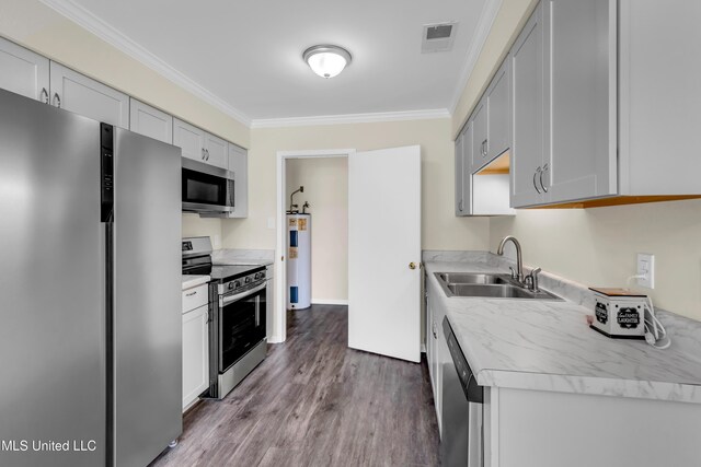 2309 Cottonwood Dr, Gulfport, MS 39503 - kitchen featuring a sink, light countertops, ornamental molding, stainless steel appliances, and electric water heater
