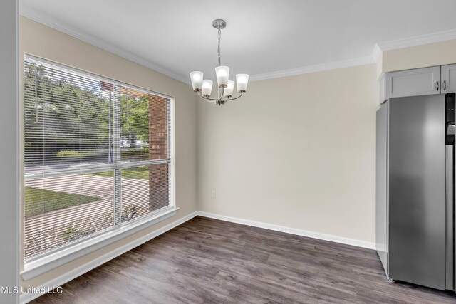 2309 Cottonwood Dr, Gulfport, MS 39503 - unfurnished dining area with crown molding, baseboards, an inviting chandelier, and dark wood-style flooring