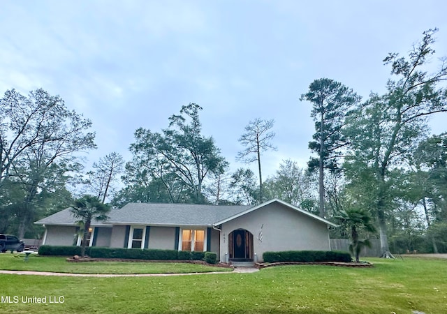 ranch-style home featuring a front yard