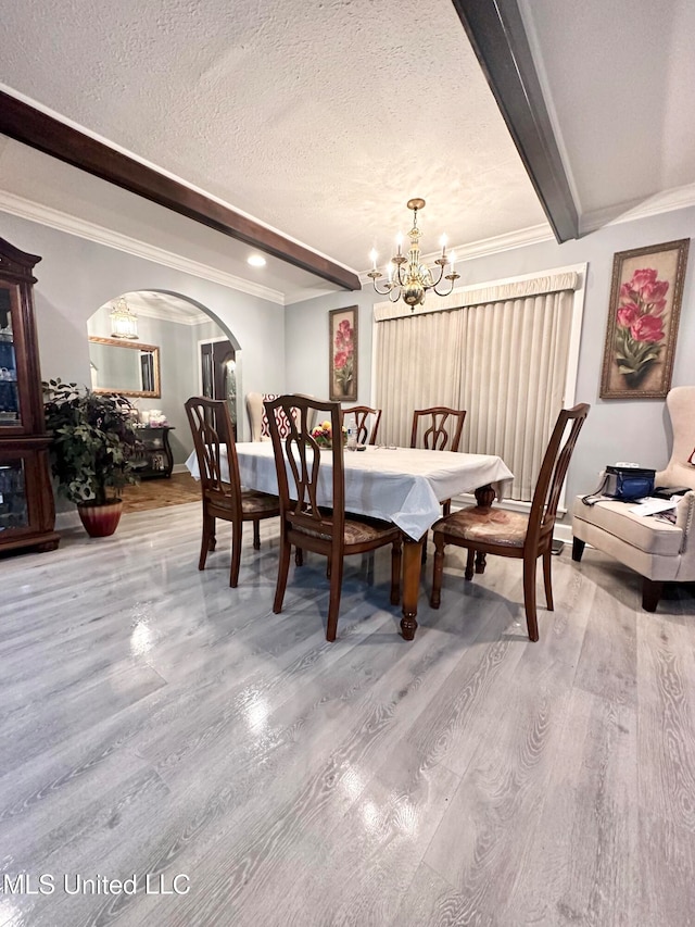 dining room with crown molding, a notable chandelier, and hardwood / wood-style flooring