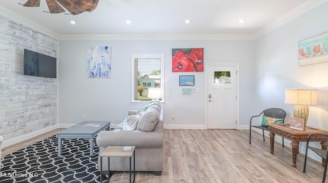 living room featuring light hardwood / wood-style floors and crown molding