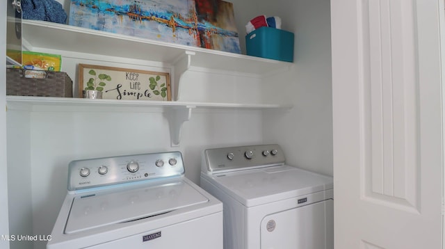 clothes washing area with separate washer and dryer