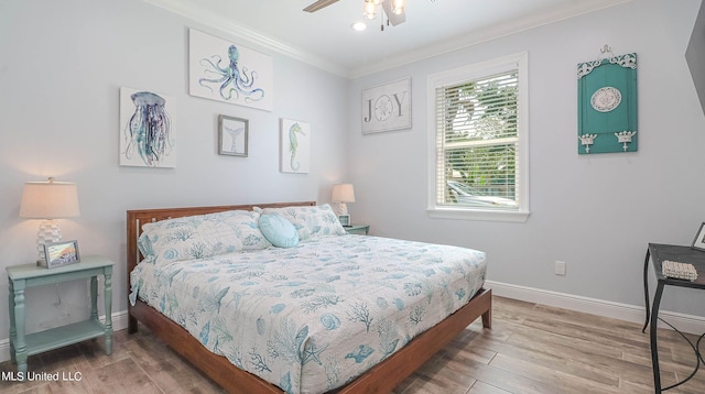 bedroom with ornamental molding, hardwood / wood-style floors, and ceiling fan