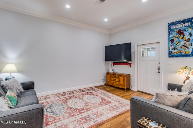 living room with crown molding and hardwood / wood-style floors