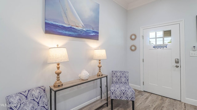 entryway featuring ornamental molding and hardwood / wood-style flooring