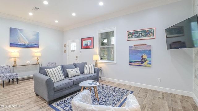 living room featuring crown molding and light wood-type flooring