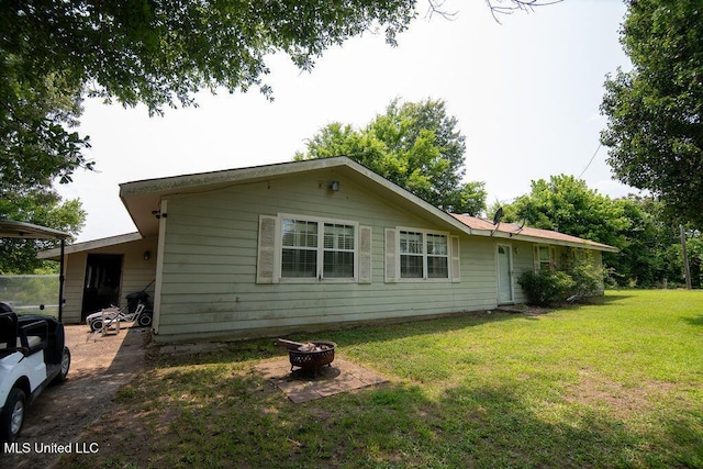 900 Old Benton Rd, Yazoo City, MS 39194 - view of side of property featuring an outdoor fire pit and a lawn