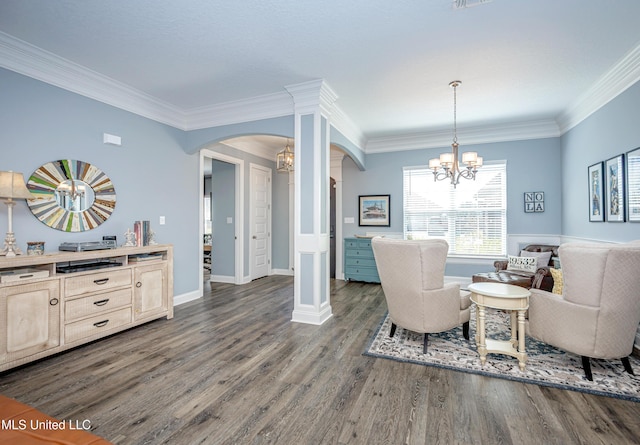 living area with dark wood-style floors, arched walkways, a notable chandelier, and ornamental molding