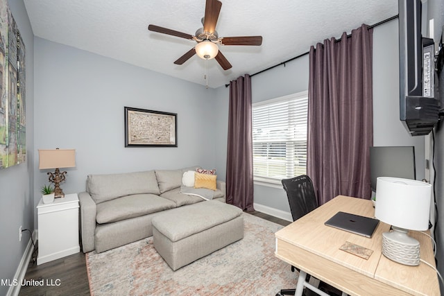 office space with a textured ceiling, wood finished floors, a ceiling fan, and baseboards