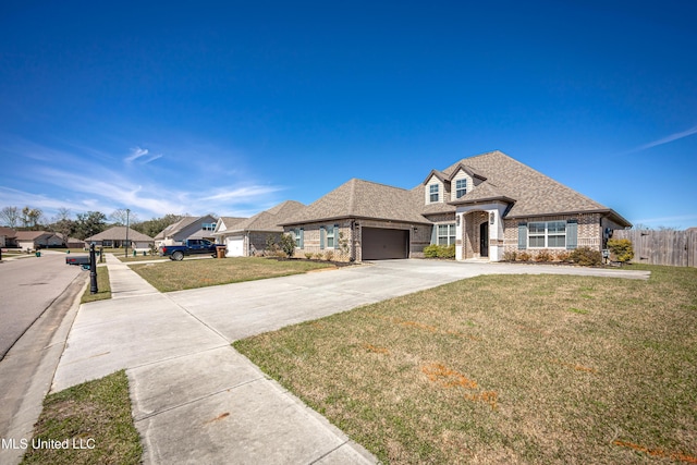 french country style house with brick siding, a shingled roof, fence, concrete driveway, and a front yard