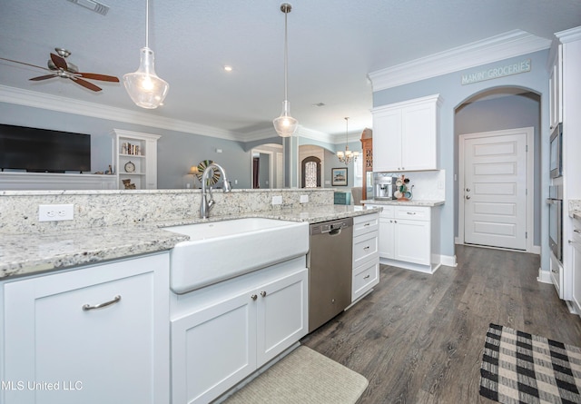 kitchen with arched walkways, crown molding, appliances with stainless steel finishes, open floor plan, and a sink