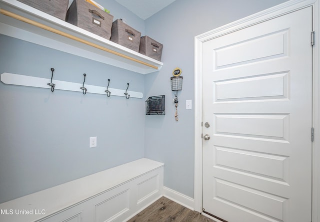 mudroom featuring baseboards and dark wood-style flooring