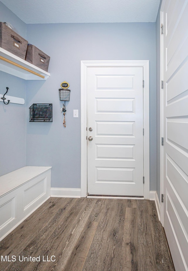 mudroom with wood finished floors and baseboards