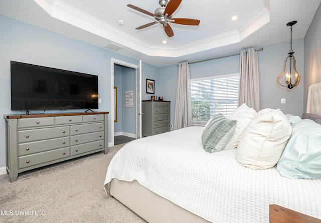 carpeted bedroom featuring a ceiling fan, a raised ceiling, crown molding, and baseboards