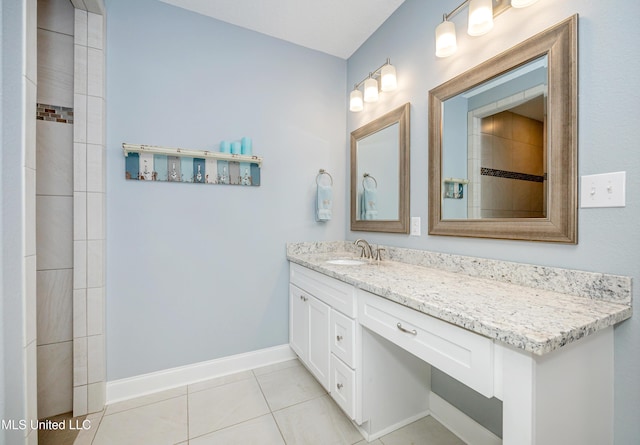 full bathroom with vanity, baseboards, and tile patterned floors