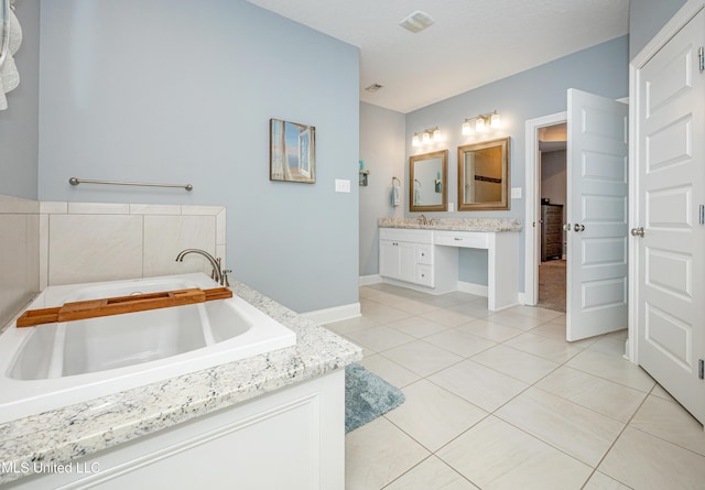 full bathroom with a garden tub, visible vents, vanity, baseboards, and tile patterned floors