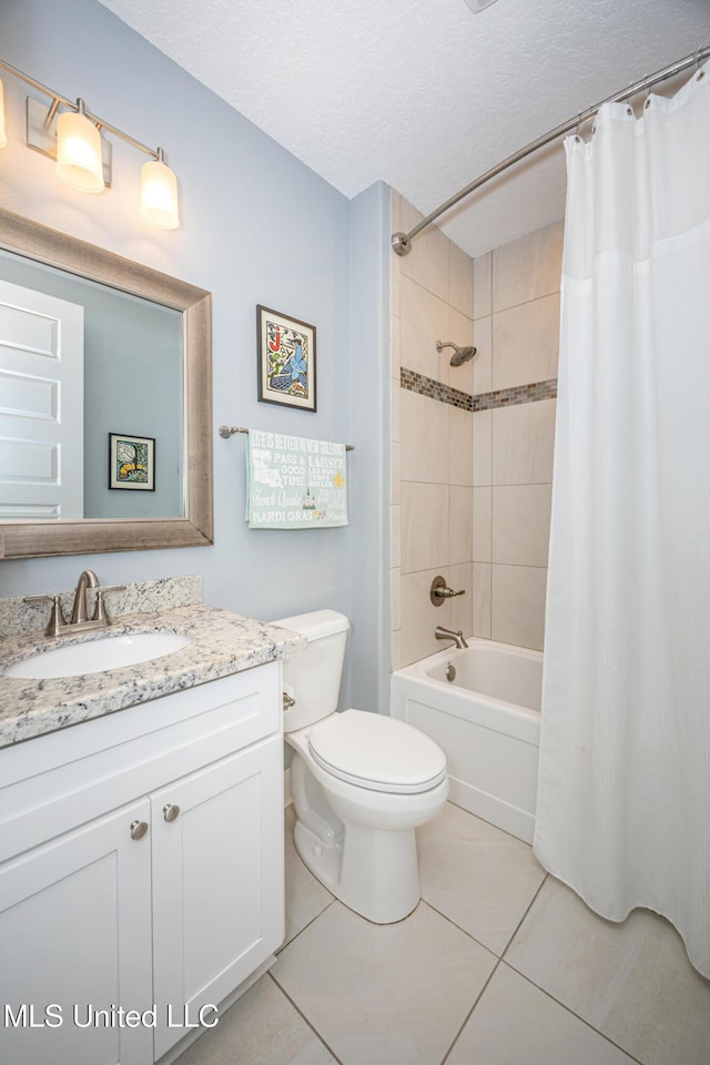 bathroom with a textured ceiling, toilet, vanity, tile patterned floors, and shower / bath combo