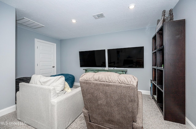 living room featuring visible vents, a textured ceiling, and baseboards