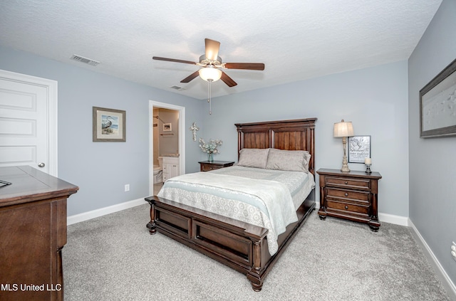 bedroom with baseboards, visible vents, a textured ceiling, and light colored carpet