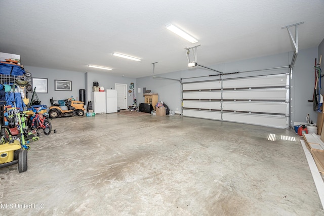 garage with freestanding refrigerator and a garage door opener