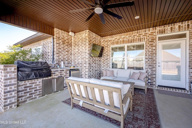 view of patio / terrace with ceiling fan, exterior kitchen, outdoor lounge area, and a grill