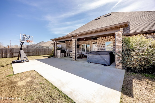 view of patio / terrace with fence and a hot tub