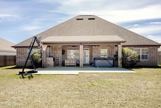 back of property featuring a patio area, fence, brick siding, and a lawn