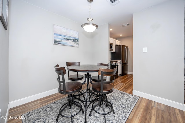 dining room with hardwood / wood-style flooring