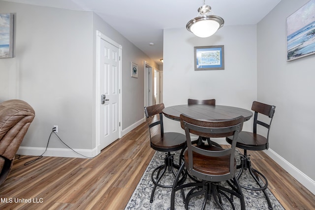 dining area featuring dark wood-type flooring