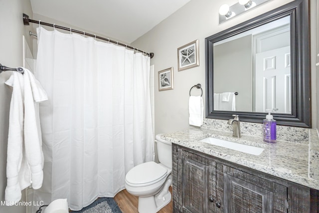 bathroom featuring hardwood / wood-style flooring, vanity, and toilet