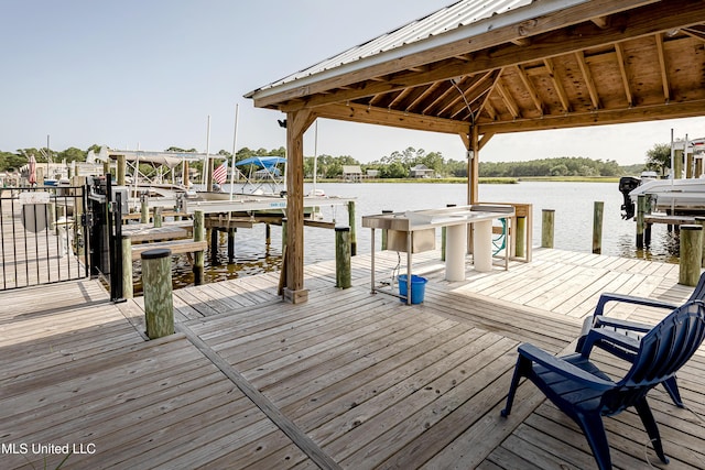 view of dock featuring a gazebo and a water view