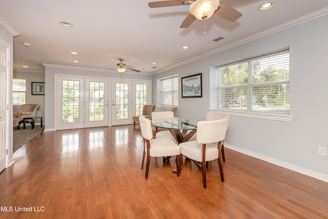 dining space with ceiling fan, a healthy amount of sunlight, and ornamental molding