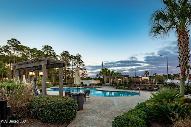 view of swimming pool with a pergola and a patio