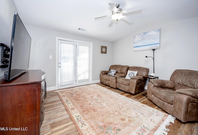 living room with ceiling fan, light hardwood / wood-style floors, and lofted ceiling