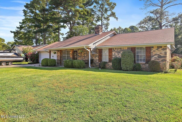 ranch-style home with a garage and a front lawn