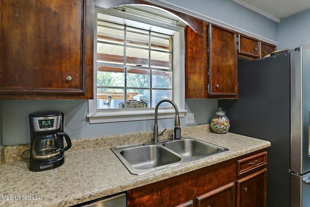 kitchen featuring sink and stainless steel refrigerator