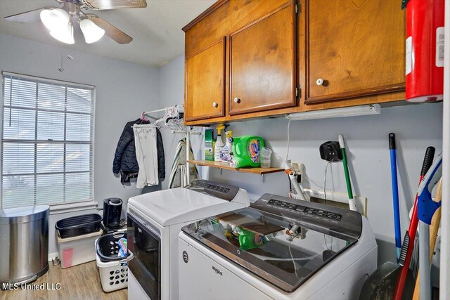 washroom with washer and clothes dryer, light hardwood / wood-style floors, cabinets, and ceiling fan