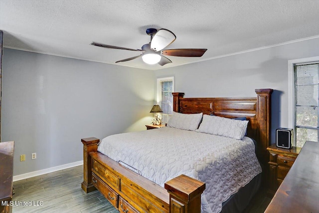 bedroom featuring ornamental molding, dark hardwood / wood-style floors, ceiling fan, and a textured ceiling