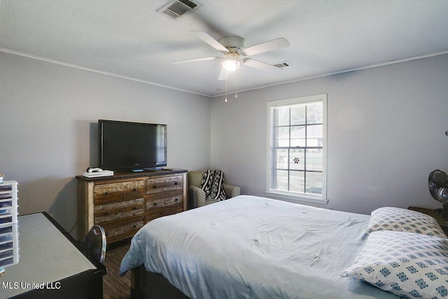 bedroom with hardwood / wood-style flooring, ceiling fan, and ornamental molding