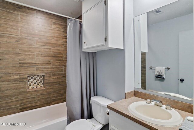 full bathroom with vanity, toilet, and shower / tub combo with curtain