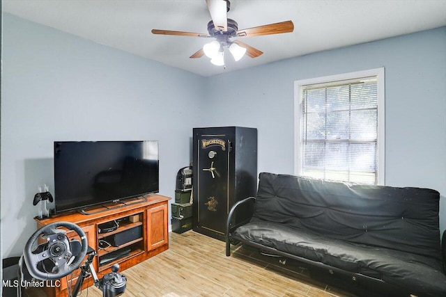 living room featuring ceiling fan and light wood-type flooring